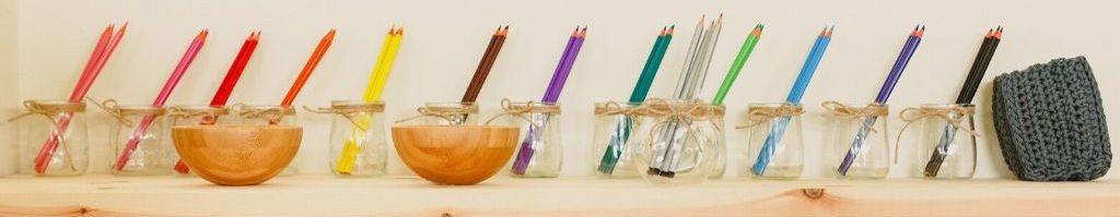 coloured pencils in individual jars